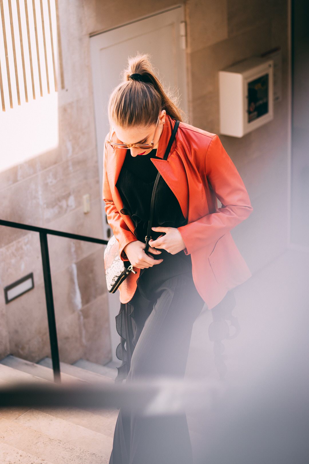 A woman walking up stairs wearing gun safe clothing