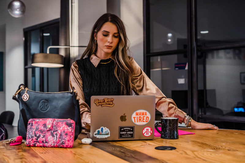 Woman working, pink and black purse