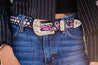Close up of a woman wearing the Muddy Girl Pink Camo Belt by Kinsey Rhea