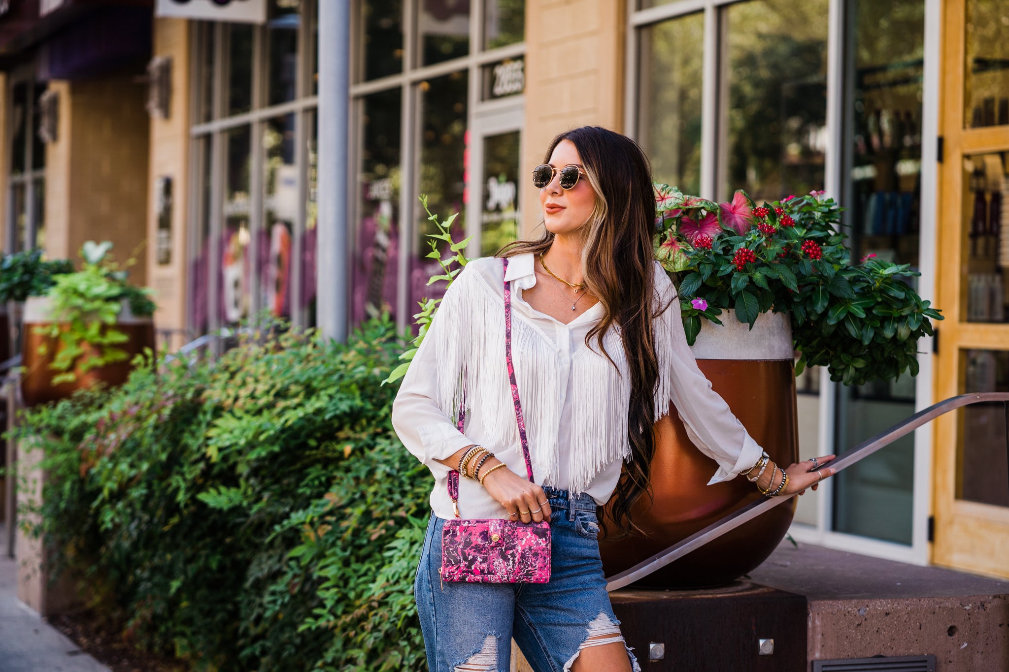 Younger woman holding the Muddy Girl Wallet Clutch by Kinsey Rhea